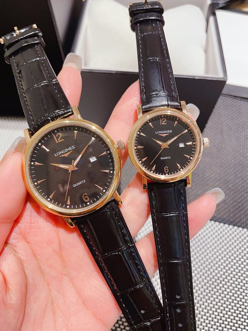 Leather-banded watch with dark dial, black strap; round gold-tone case.