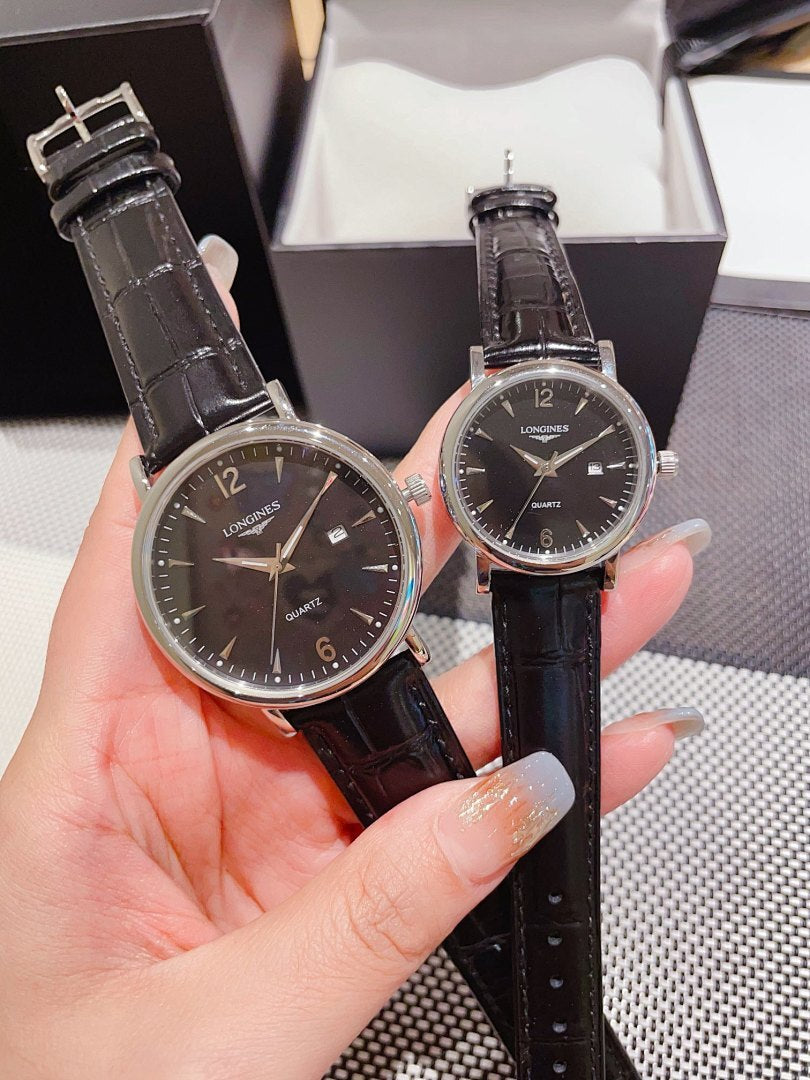Leather-banded watch with dark dial, black strap; round silver-tone cases.