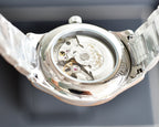 Longines automatic watch caseback view with exposed inner mechanisms