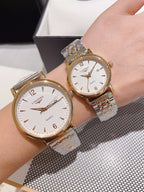 Pair of Longines watches with white dial and gold-toned bezel, metal link straps