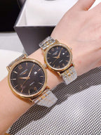 Pair of Longines watches with dark dials and gold-toned bezels, steel link bracelets