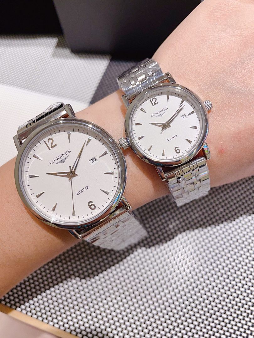 Pair of Longines watches with white dials, gold-toned cases, metal link bracelets