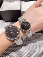 Pair of Longines stainless steel watches with dark dials, metal link bracelets