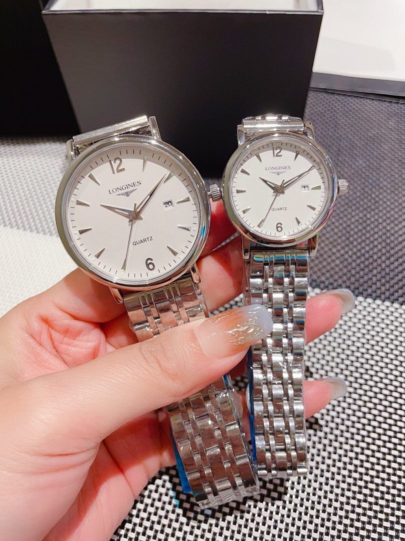 Pair of Longines watches with white dials and gold-toned cases, steel link bracelets
