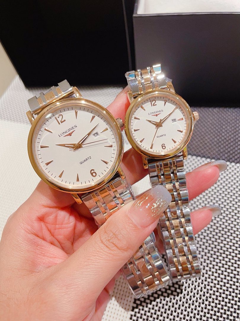 Pair of Longines watches with white dial and gold accents, metal link bracelets