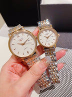 Pair of Longines watches with white dial and gold accents, metal link bracelets