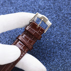 Longines watch with brown leather strap and silver buckle