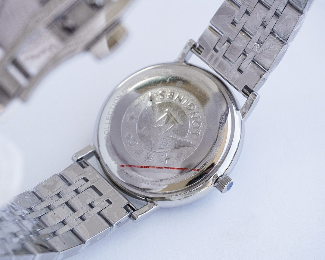 Longines wristwatch caseback with engraved emblem and stainless steel bracelet links