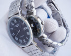 Longines quartz wristwatch close-up with black dial and stainless steel bracelet