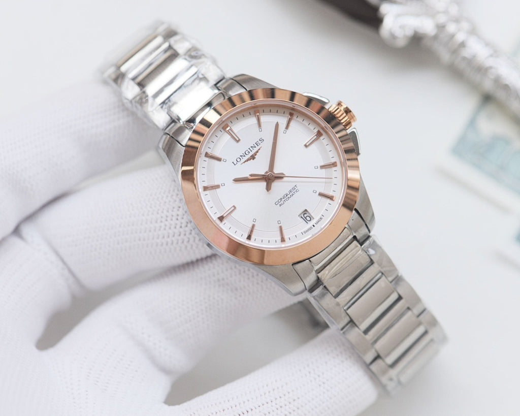 Longines watch with white dial, rose-tone bezel, and silver stainless bracelet