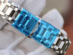 Longines wristwatch bracelet detail with bright blue case band and polished silver links