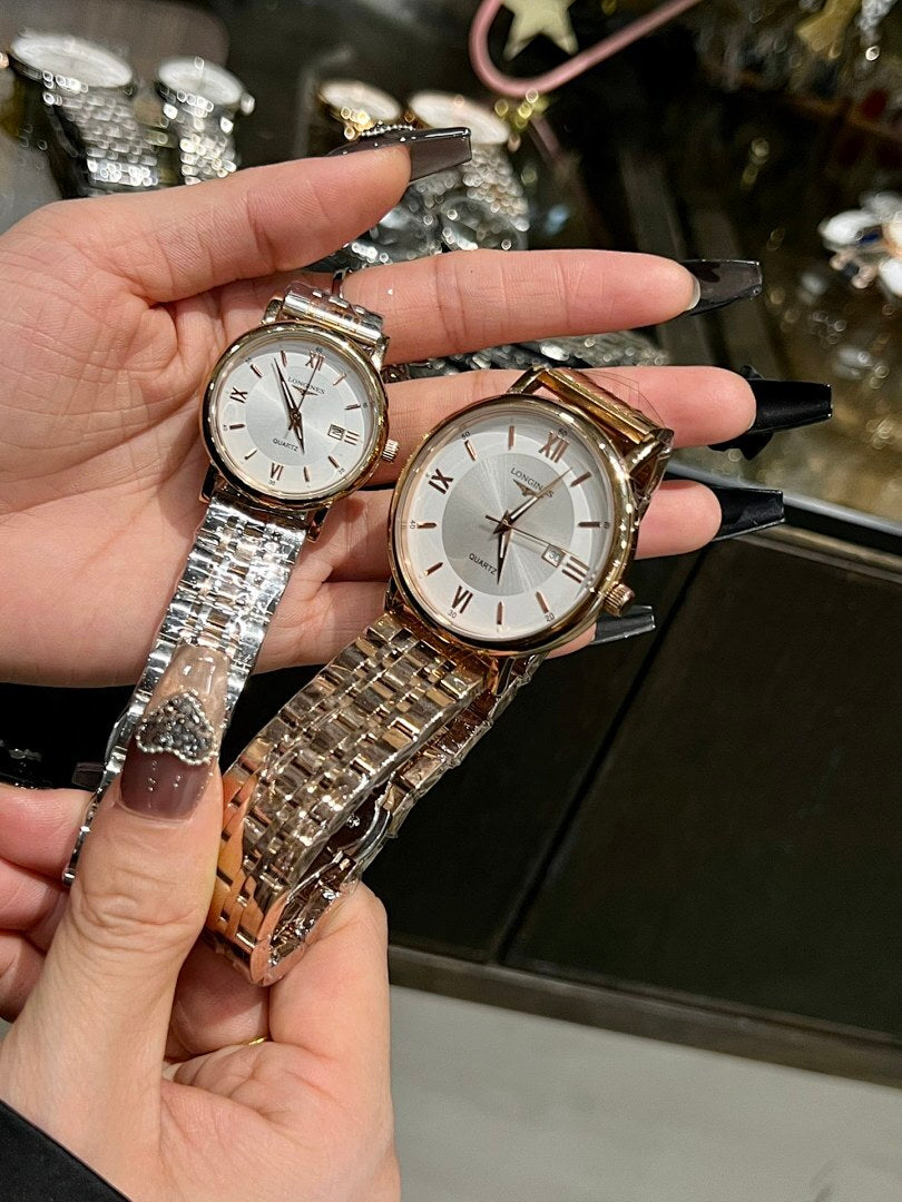 Pair of round wristwatches with white dials and silver metal link bracelets