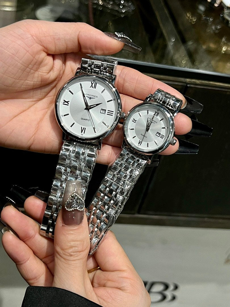 Two round wristwatches with white dials and silver metal link bracelets