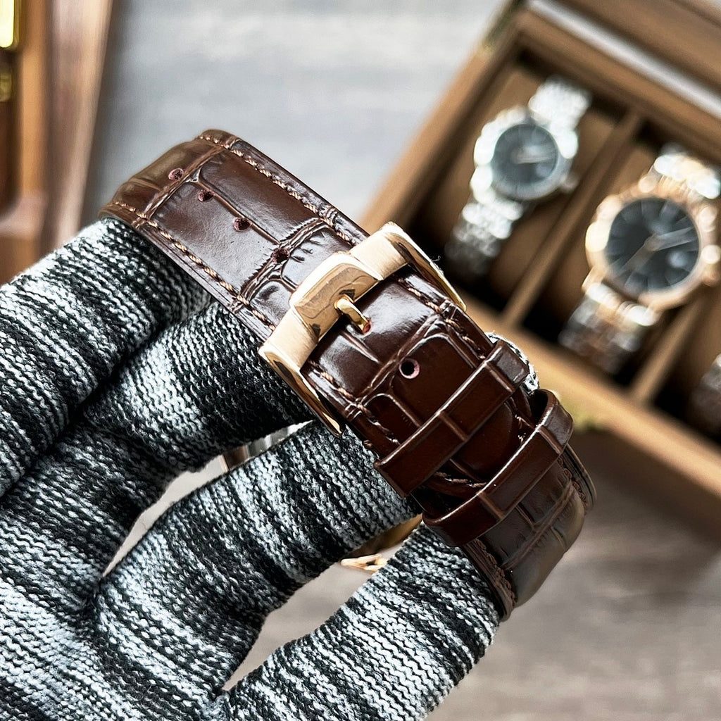 Longines watch with brown leather strap and metal buckle on knit cuff