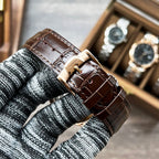 Longines watch with brown leather strap and metal buckle on knit cuff