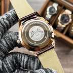 Longines watch caseback on light tan leather strap with engraved medallion