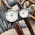 Pair of Longines quartz watches with white dials and brown leather straps