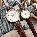 Pair of Longines quartz watches with white dials and brown leather straps
