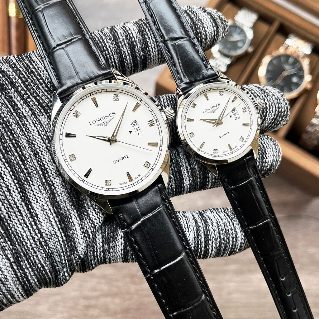 Pair of Longines quartz watches with white dials and black leather straps
