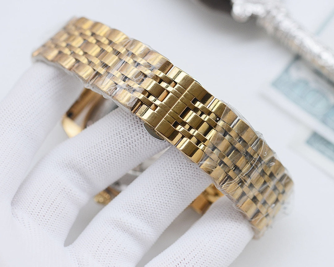 Longines watch with gold tone bracelet link detail in close-up