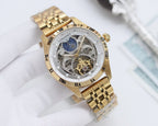 Longines watch with gold tone bracelet and round silver skeleton dial with blue moon detail