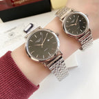 Stainless steel wristwatch with dark dial, round case, metal link bracelet strap