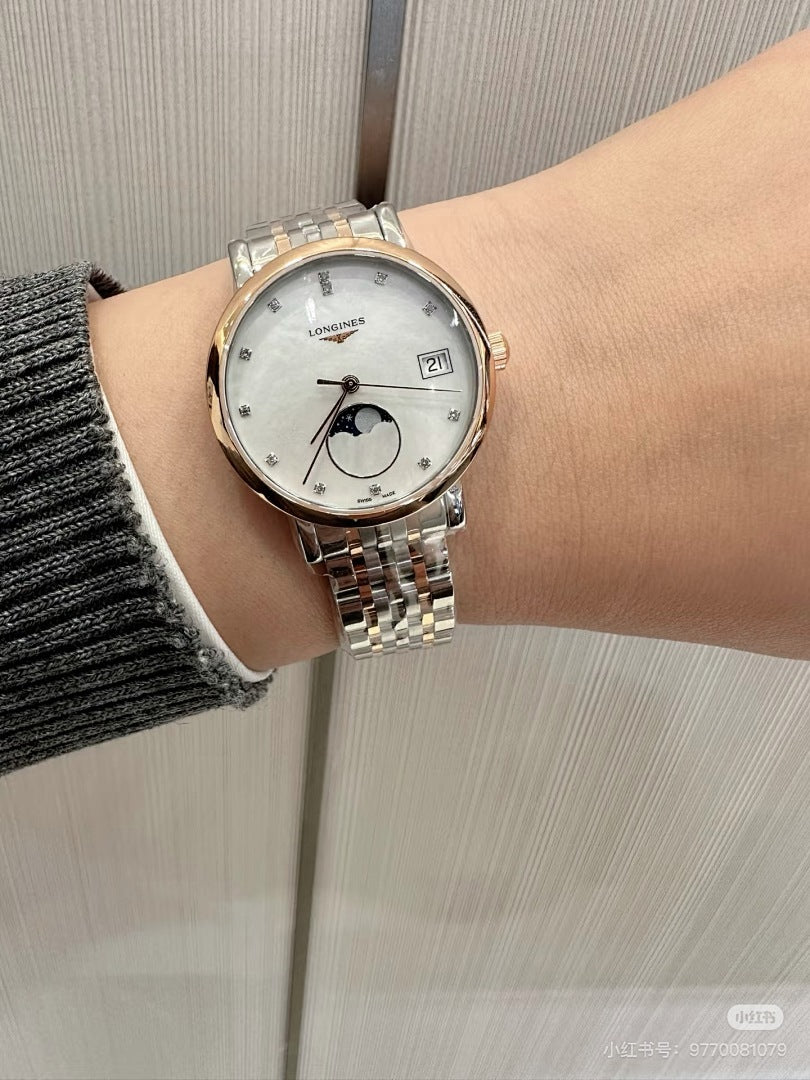 Longines wristwatch on a wrist, rose-gold tone case, silver metal bracelet, white dial