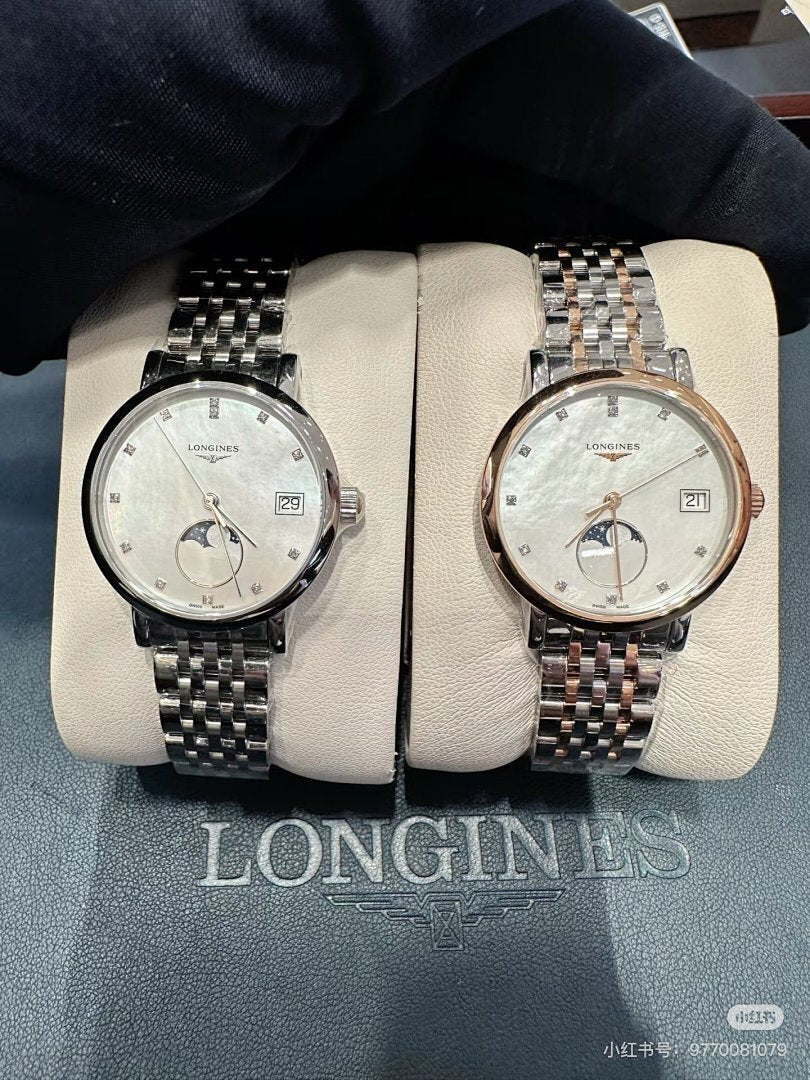 Pair of Longines wristwatches on a display pad, silver and rose-gold tone metal bracelets