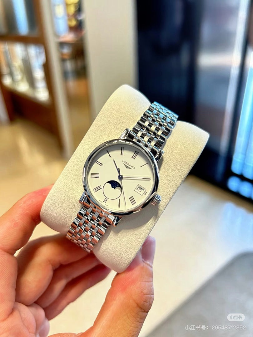 Longines wristwatch on a hand, silver bracelet with blue-tinted links and white dial