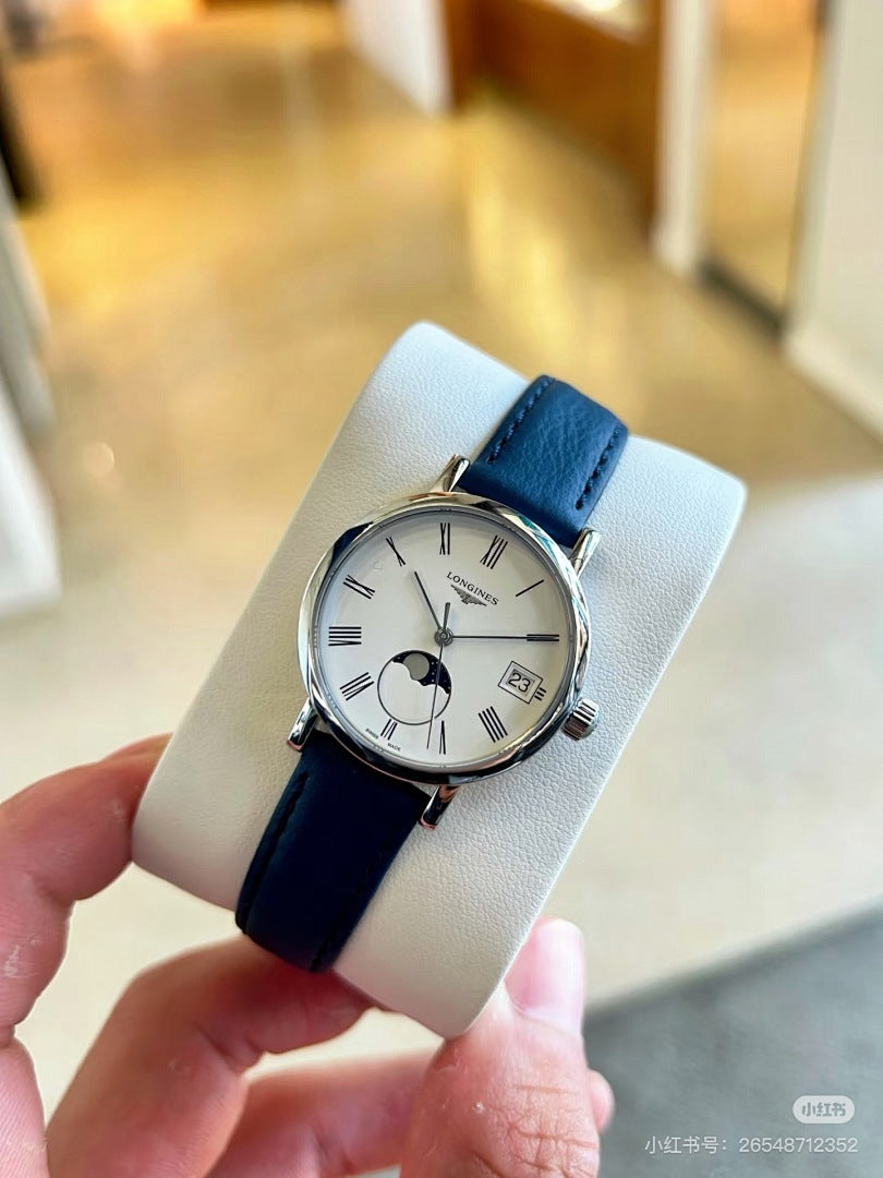 Longines wristwatch with blue leather strap, silver case, white dial on a wrist