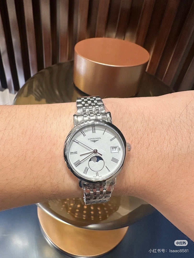 Longines wristwatch on an arm, silver metal bracelet and white dial with moon-phase subdial