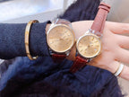 Two Longines wristwatches with tan and light pink leather straps, round cream dials