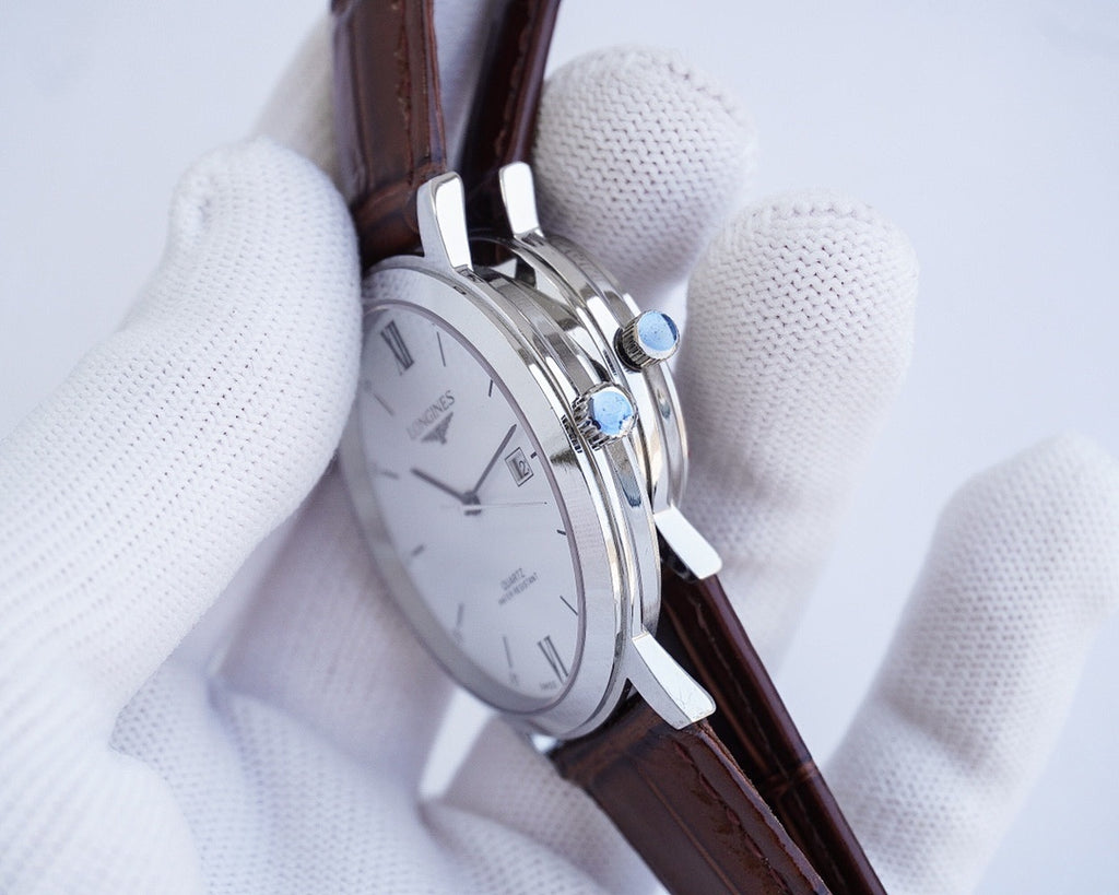 Longines watch with silver case and brown leather strap, side crown detail