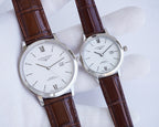 Longines watch pair with white dial, Roman numerals, and brown crocodile leather straps
