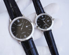 Longines watch pair with black dial and Roman numerals, black leather straps