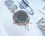 Longines round watch with dark starry back dial and silver metal bracelet