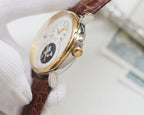 Gold-cased wristwatch with brown leather strap and white dial, gold crown at 3 o'clock