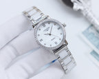 Longines watch with silver metal link bracelet, white dial, and crystal-studded bezel