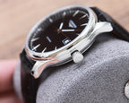 Longines automatic watch with black dial, silver-tone case, and black leather strap