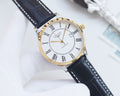 Longines wristwatch with white dial, Roman numerals, gold-tone bezel, dark leather strap