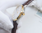 Longines wristwatch with silver case and dark leather strap, side view with crown