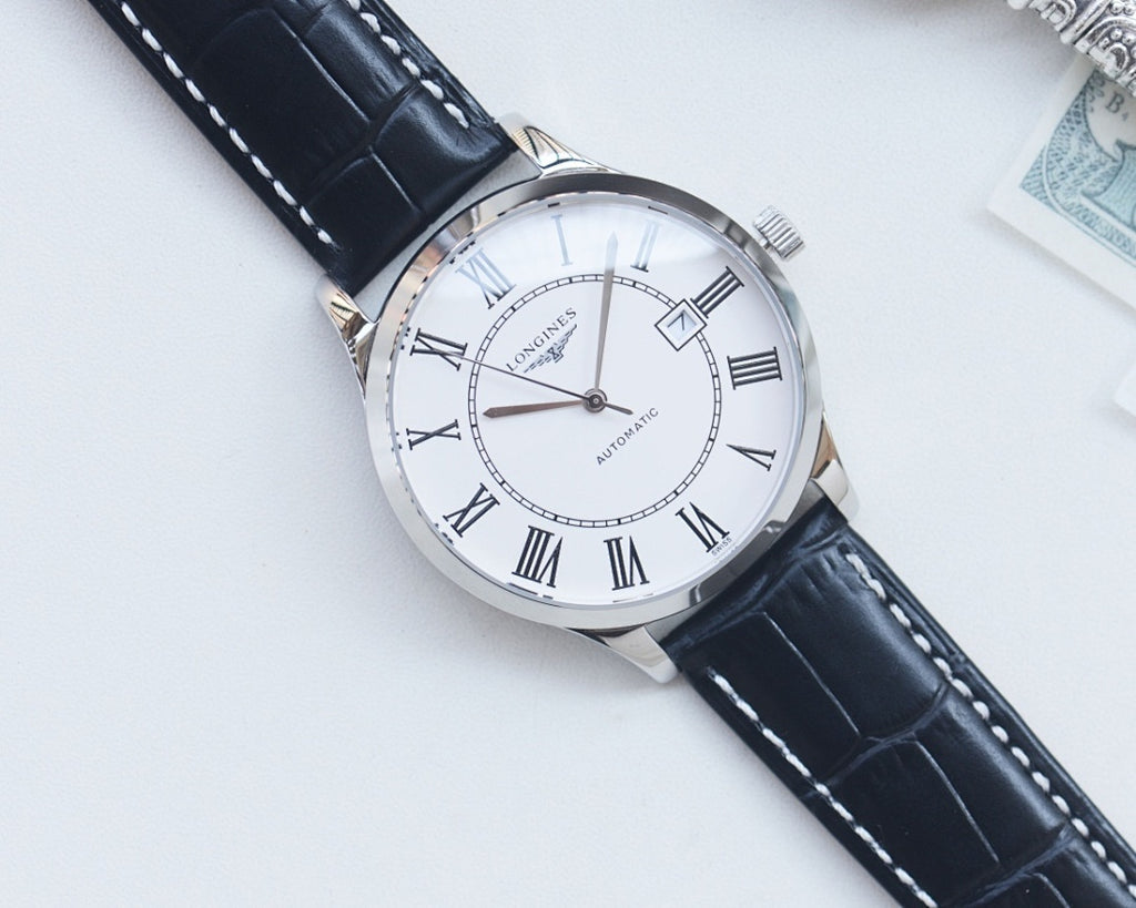 Longines automatic wristwatch with white dial, Roman numerals, silver case, dark leather strap