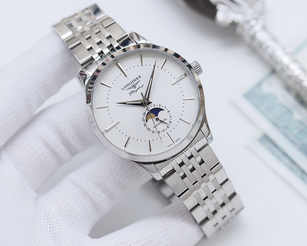 Wristwatch with white dial and silver link bracelet, gold-tone accents.