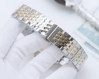 Two-tone wristwatch bracelet with alternating silver and gold-tone links.
