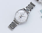 Wristwatch with white dial and silver link bracelet, angled view.