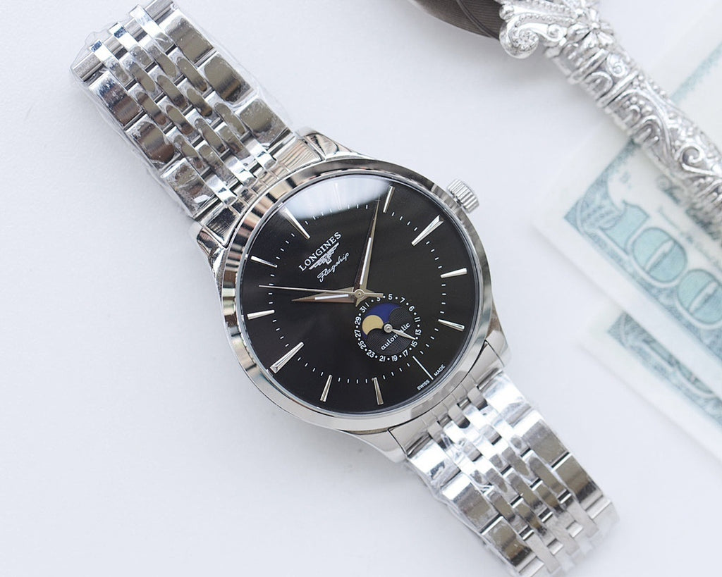 Wristwatch with black dial, silver link bracelet, gold-tone hour markers.