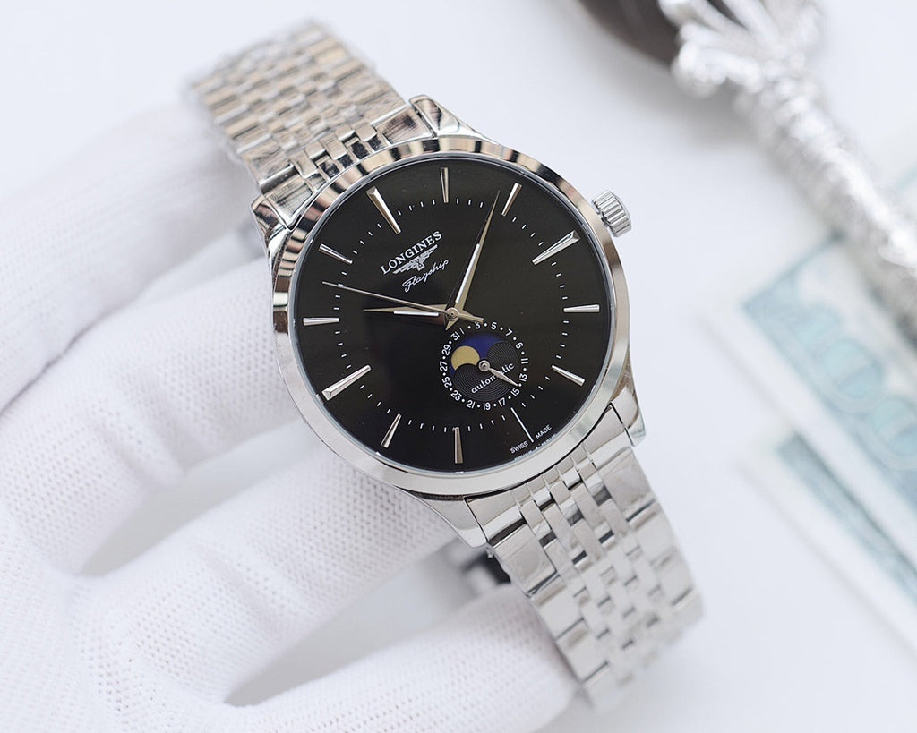 Wristwatch with black dial and silver link bracelet, gold-tone accents.