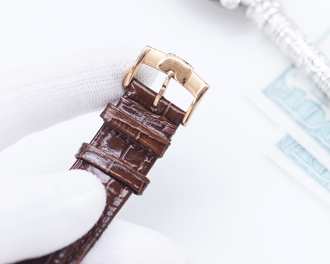 Longines watch crown and brown leather strap with buckle clasp