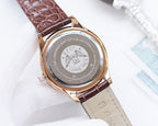 Longines watch caseback with engraved logo on brown leather strap