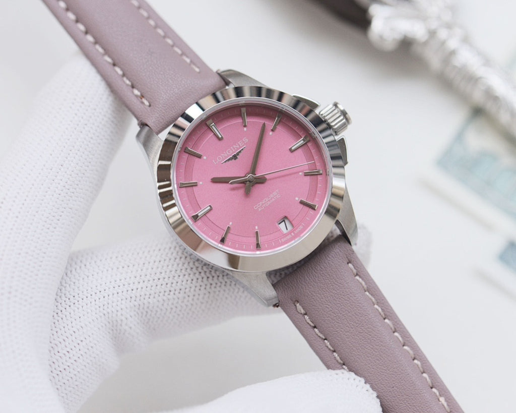 Round wristwatch with pink dial and lavender leather strap, silver bezel